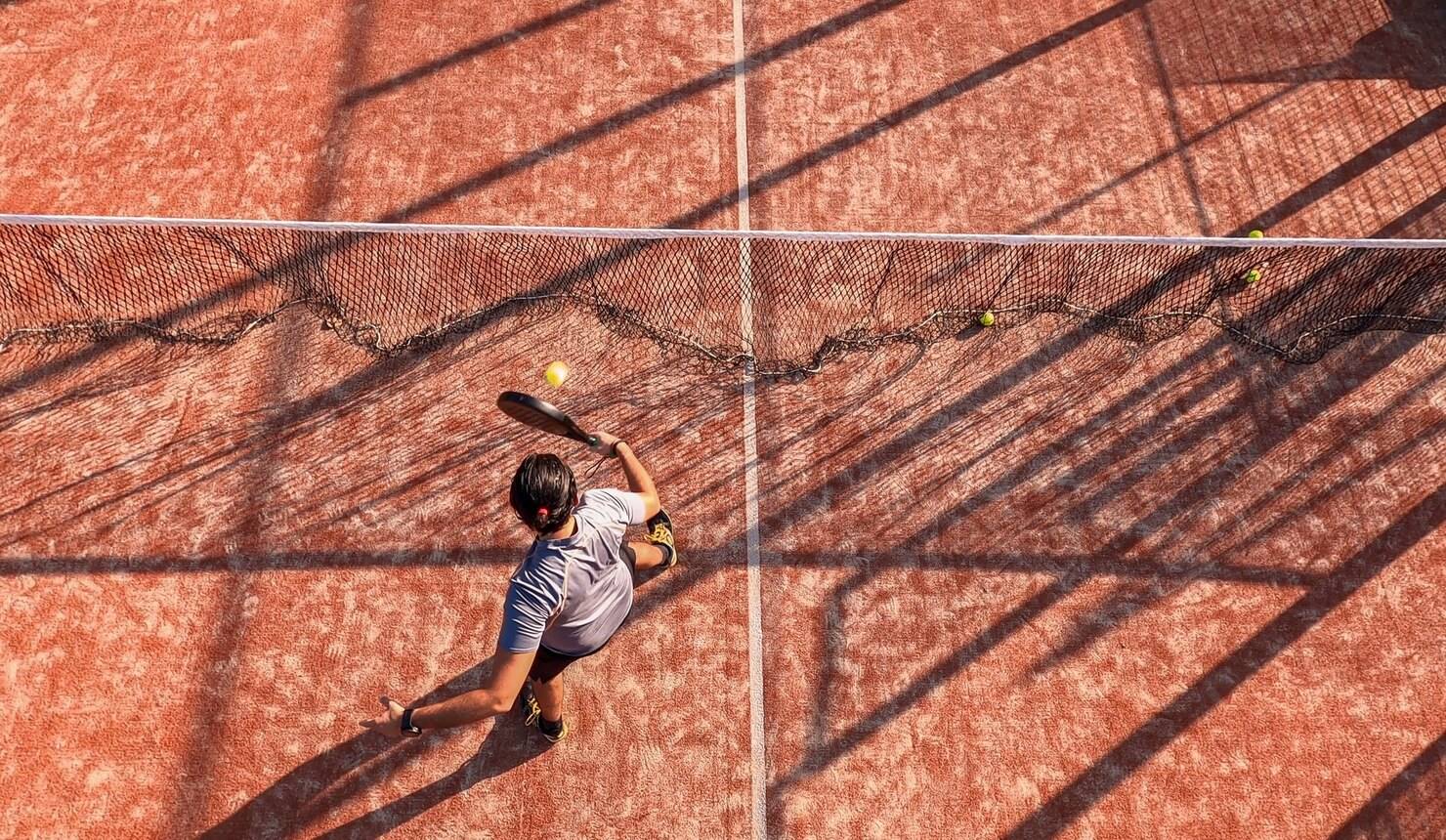 top-view-professional-paddle-tennis-player-hitting-ball-near-net-outdoor-court_352173-2388.jpg